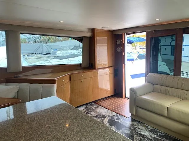 Slide: The Image of Interior of 2002 Viking 55 Convertible yacht with modern furnishings and large windows. - 20