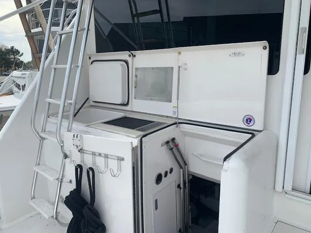 Slide: The Image of 2002 Viking 55 Convertible yacht deck with ladder and storage compartments. - 22