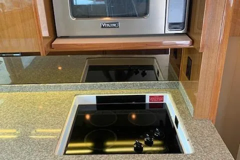 Slide: The Image of Kitchen area of 2002 Viking 55 Convertible with stove and microwave. - 29