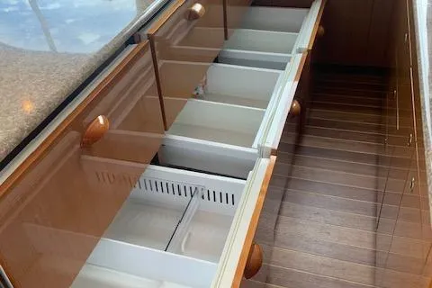 Slide: The Image of Empty kitchen drawers in a 2002 Viking 55 Convertible yacht interior. - 30