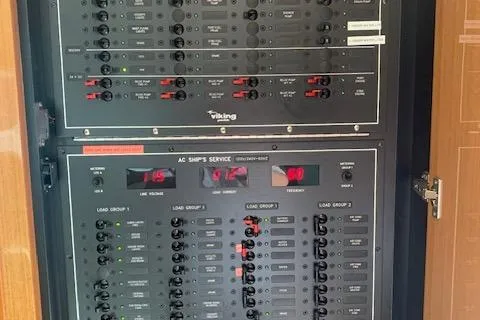 Slide: The Image of Electrical panel of a 2002 Viking 55 Convertible yacht with various switches and indicators. - 31