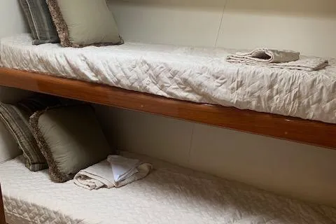 Slide: The Image of Bunk beds in 2002 Viking 55 Convertible yacht cabin with pillows and folded towels. - 33