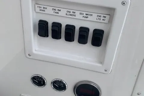 Slide: The Image of Control panel of a 2002 Viking 55 Convertible boat with labeled switches and gauges. - 37