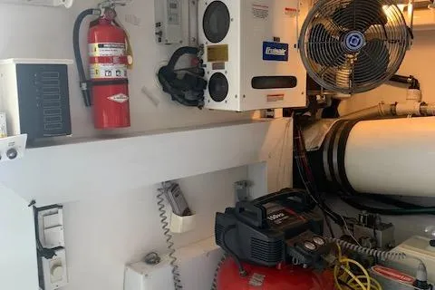 Slide: The Image of Engine room of a 2002 Viking 55 Convertible yacht with equipment and safety gear. - 45