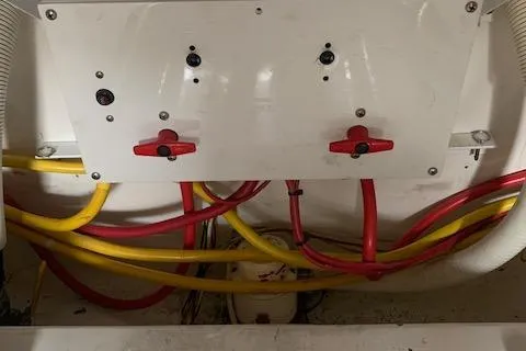 Slide: The Image of Engine room wiring of a 2002 Viking 55 Convertible boat with red and yellow cables. - 47