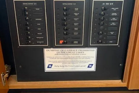 Slide: The Image of Electrical panel on a 2002 Viking 55 Convertible boat with environmental notice. - 48