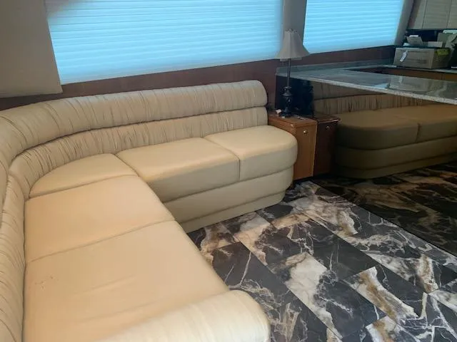 Slide: The Image of Interior of 2002 Viking 55 Convertible yacht with beige seating and marble flooring. - 8