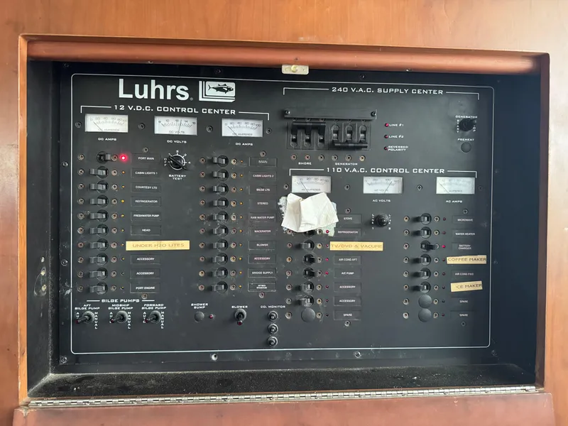 Slide: The Image of Luhrs 36 Convertible 2004 control panel with switches and indicators for electrical systems. - 15