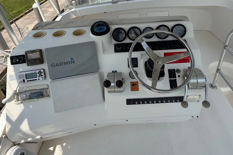 Slide: The Image of 2004 Luhrs 36 Convertible helm with Garmin navigation and control instruments. - 8