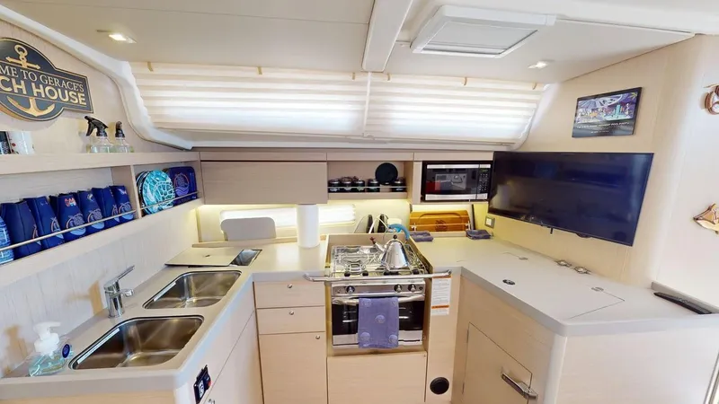 Slide: The Image of Interior of 2021 Beneteau Oceanis 40.1 yacht kitchen with modern amenities and sleek design. - 10