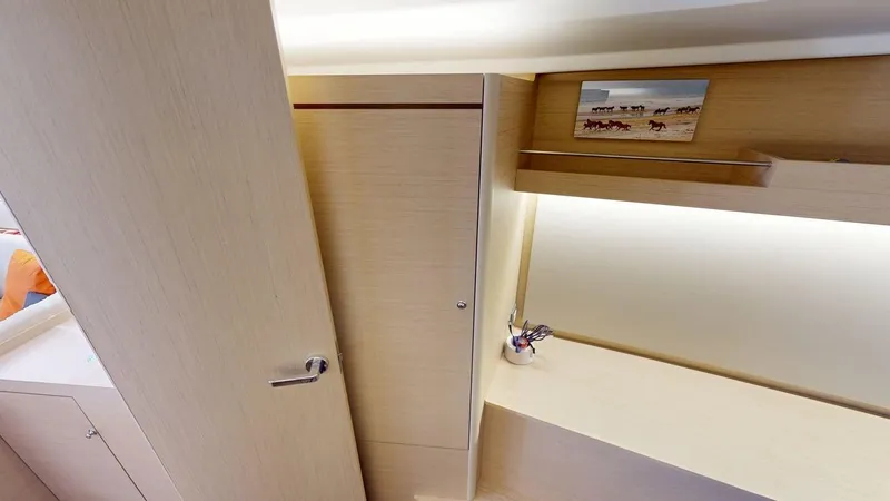 Slide: The Image of Interior of 2021 Beneteau Oceanis 40.1 yacht, featuring light wood cabinetry and modern design. - 14