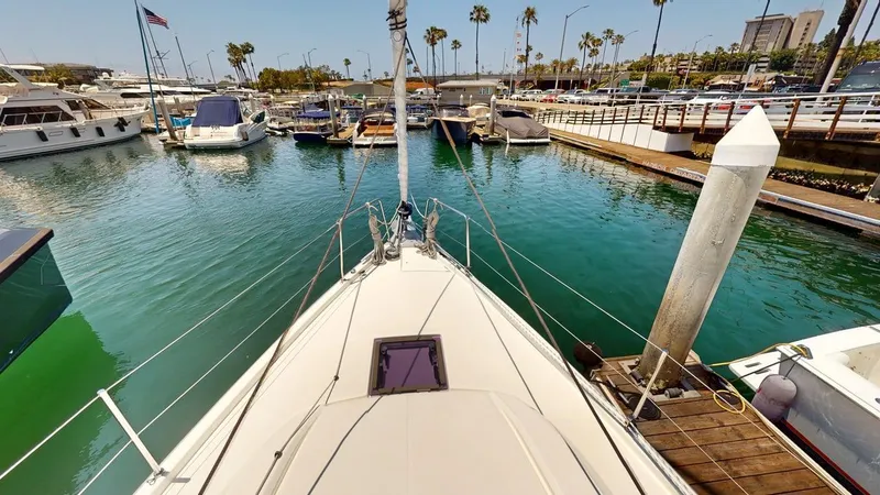 Slide: The Image of Bow view of 2021 Beneteau Oceanis 40.1 yacht docked in a marina with palm trees. - 20