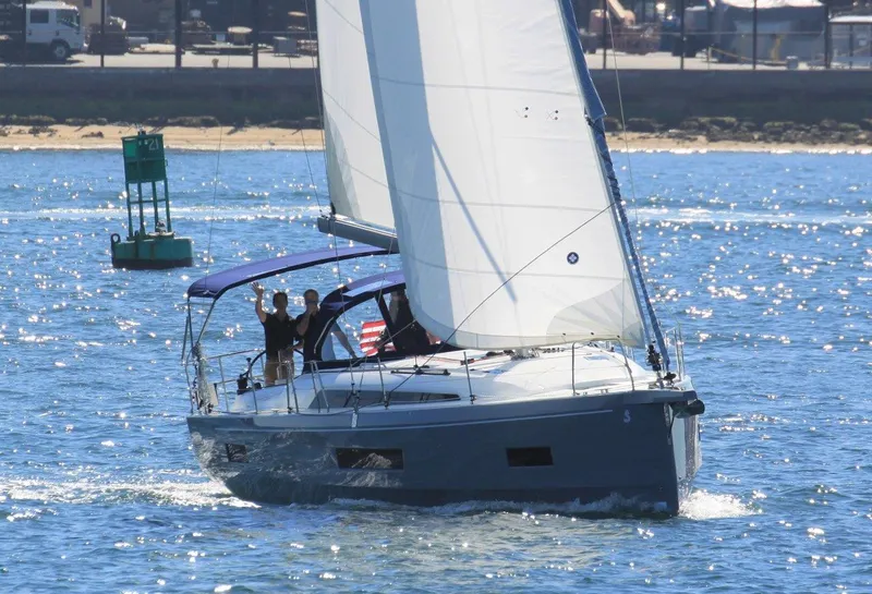 Slide: The Image of 2021 Beneteau Oceanis 40.1 sailing on open water with people onboard. - 29