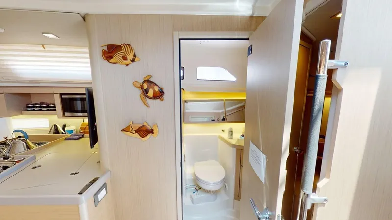 Slide: The Image of Interior of 2021 Beneteau Oceanis 40.1 yacht, featuring bathroom and kitchen area. - 6
