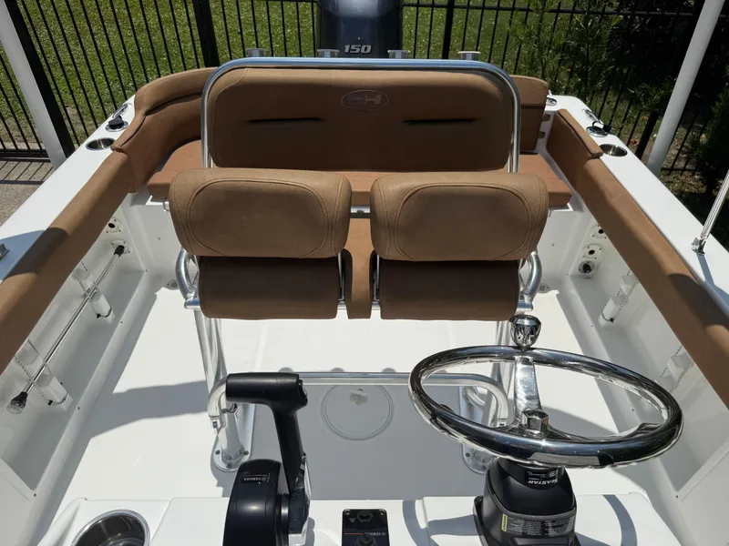 Slide: The Image of 2021 Sea Hunt Ultra 219 boat interior with steering wheel and seating. - 12