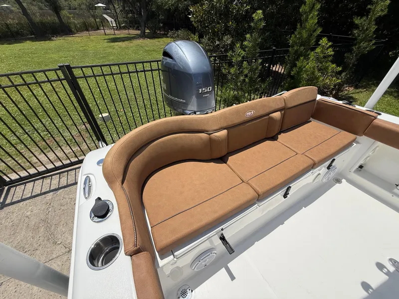 Slide: The Image of 2021 Sea Hunt Ultra 219 boat with brown seating and Yamaha 150 outboard motor. - 13