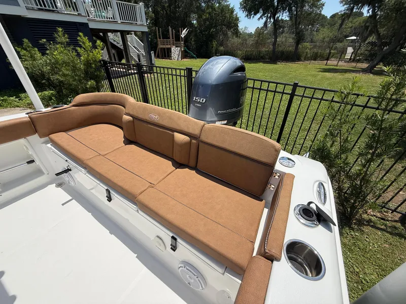 Slide: The Image of 2021 Sea Hunt Ultra 219 boat with cushioned seating and Yamaha outboard motor. - 14