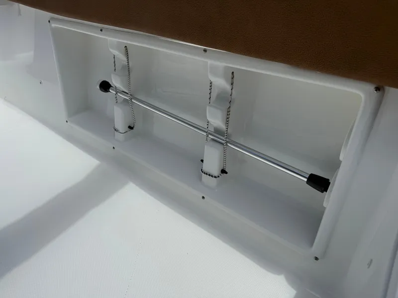 Slide: The Image of Storage compartment in 2021 Sea Hunt Ultra 219 boat, featuring secure rod holders. - 21