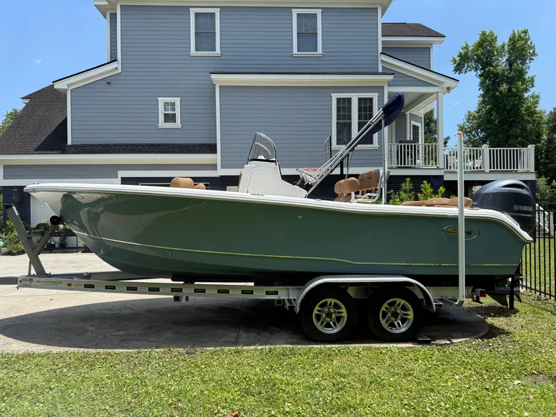Slide: The Image of 2021 Sea Hunt Ultra 219 boat on trailer, parked in front of a blue house. - 4