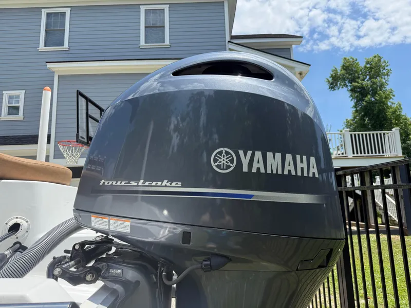 Slide: The Image of Yamaha four-stroke engine on 2021 Sea Hunt Ultra 219 boat, residential background. - 7