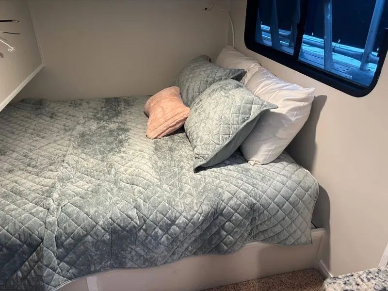 Slide: The Image of Cozy bedroom in 1992 Lakeview houseboat with quilted bedding and window view. - 12