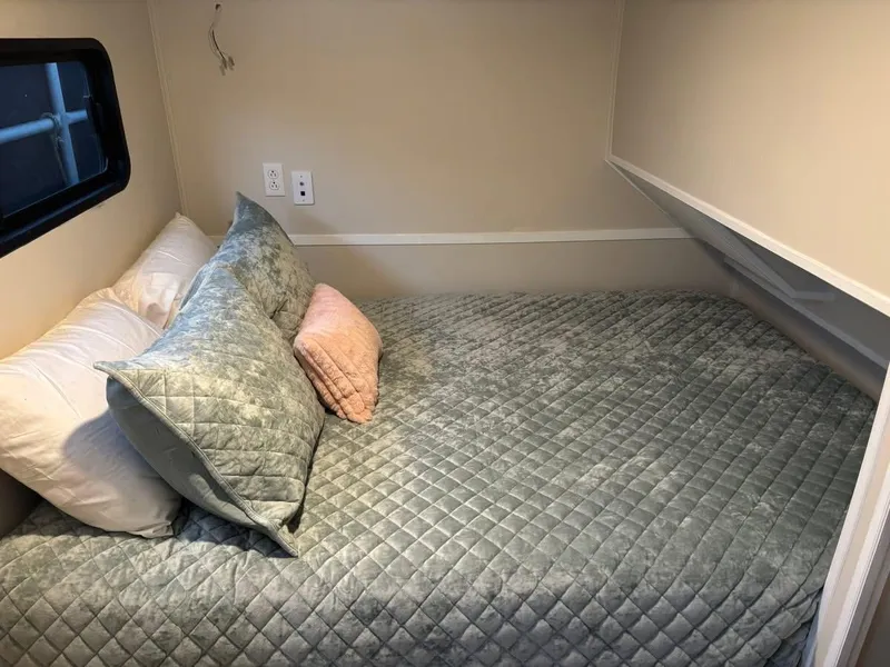 Slide: The Image of Cozy bedroom in 1992 Lakeview houseboat with quilted bedding and soft pillows. - 13