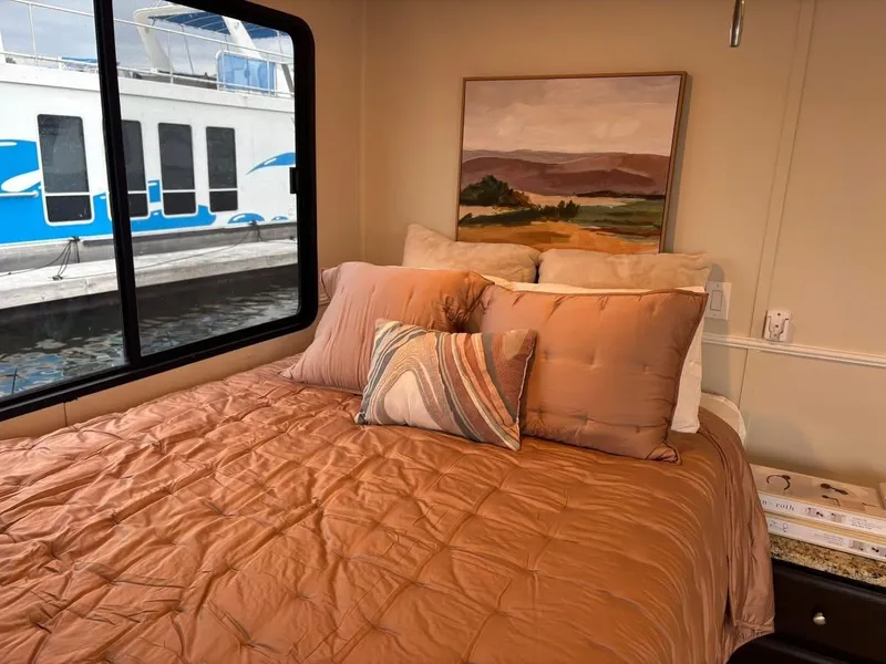 Slide: The Image of Cozy bedroom in 1992 Lakeview houseboat with scenic painting and water view. - 14