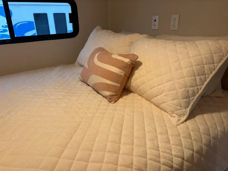 Slide: The Image of Cozy bedroom in 1992 Lakeview houseboat with quilted bedding and decorative pillows. - 5