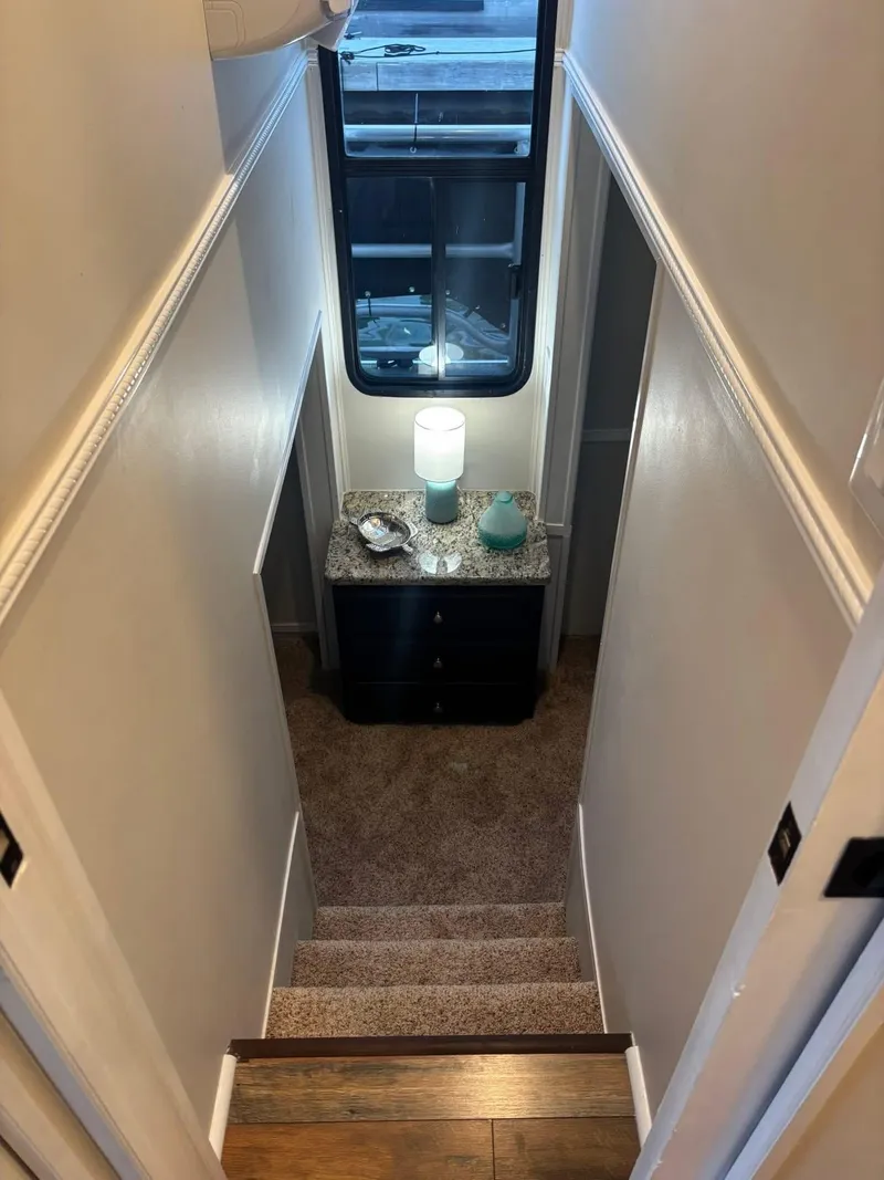 Slide: The Image of Narrow stairway in 1992 Lakeview houseboat with carpet and decorative table. - 6