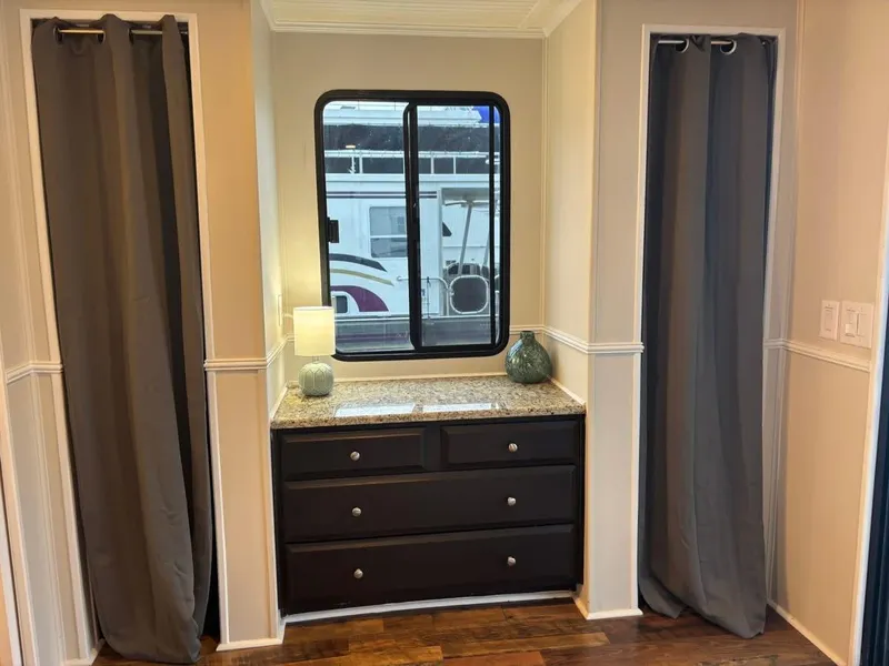 Slide: The Image of Interior of 1992 Lakeview Houseboat with window, curtains, and dresser. - 7