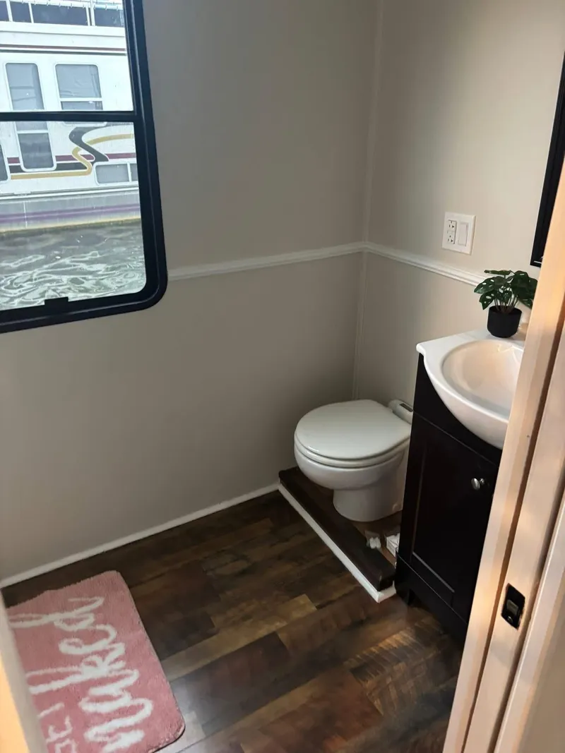 Slide: The Image of Bathroom interior of 1992 Lakeview houseboat with toilet, sink, and window view. - 8