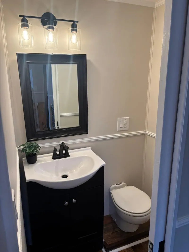 Slide: The Image of Compact bathroom on 1992 Lakeview houseboat with modern fixtures and lighting. - 9