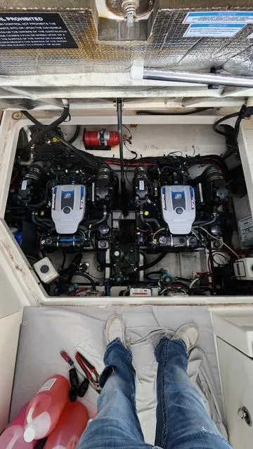 Slide: The Image of Engine compartment of a 2010 Sea Ray 310 Sundancer with dual engines visible. - 12