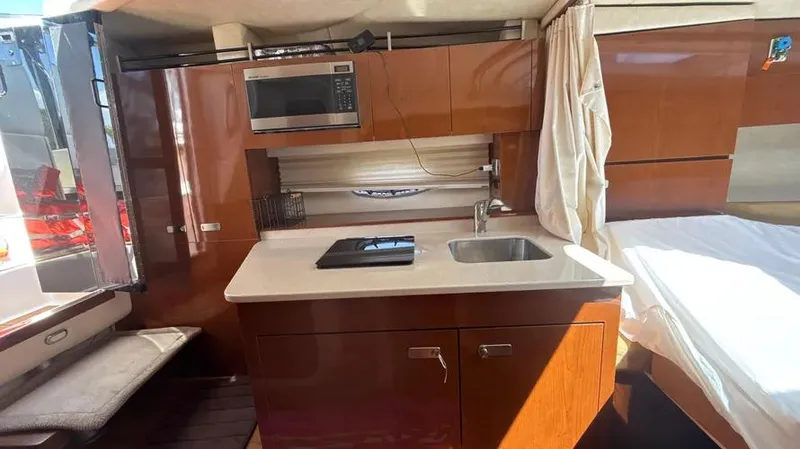 Slide: The Image of Interior of 2010 Sea Ray 310 Sundancer with kitchenette and bed. - 6