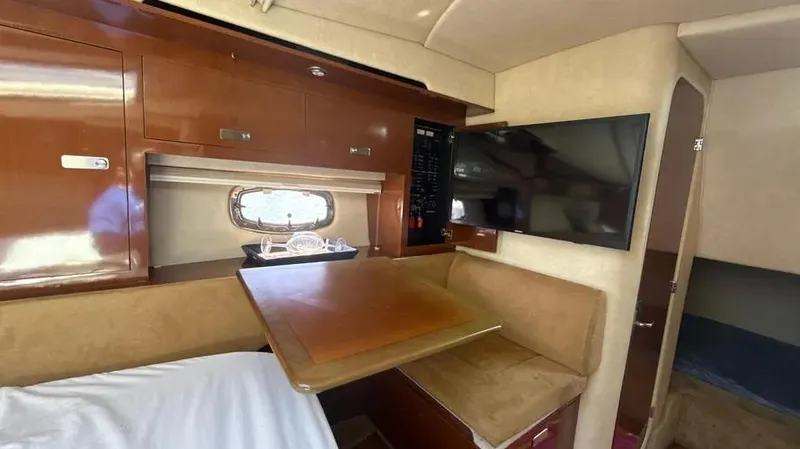 Slide: The Image of Interior of 2010 Sea Ray 310 Sundancer with wood cabinetry and seating area. - 7