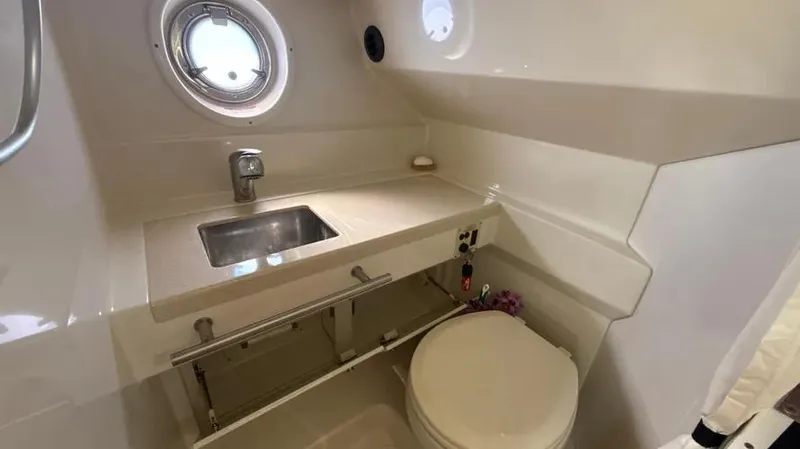 Slide: The Image of Bathroom interior of 2010 Sea Ray 310 Sundancer yacht with sink and porthole. - 9