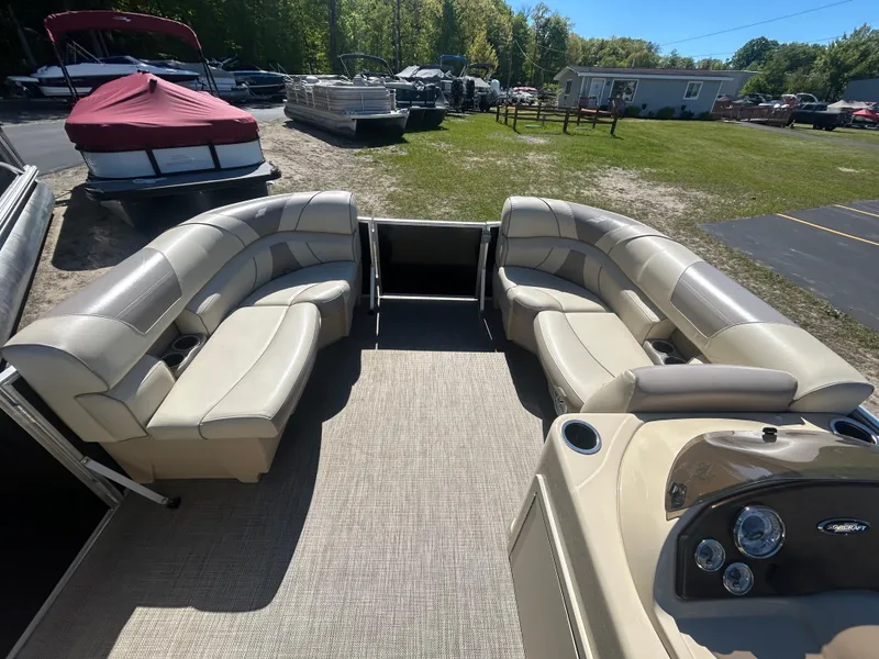 Slide: The Image of 2019 Starcraft EX 20 C pontoon boat interior with beige seating and control panel. - 11