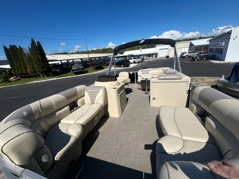 Slide: The Image of 2019 Starcraft EX 20 C pontoon boat with beige seating, docked under clear blue skies. - 14