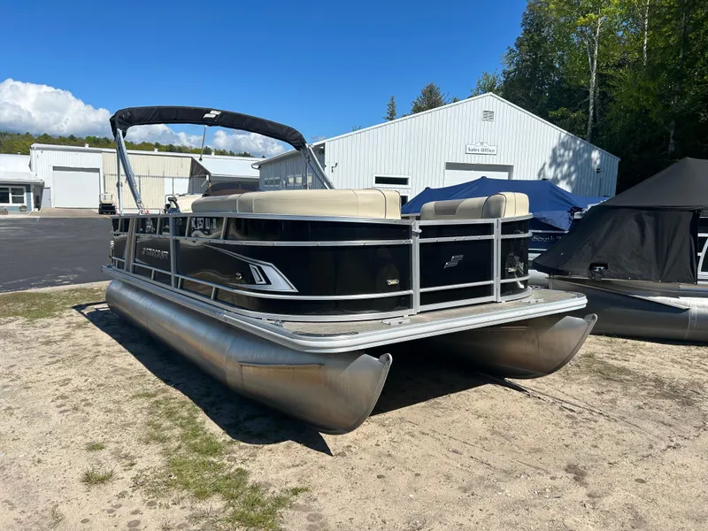 Slide: The Image of 2019 Starcraft EX 20 C pontoon boat parked outdoors near a sales office. - 3