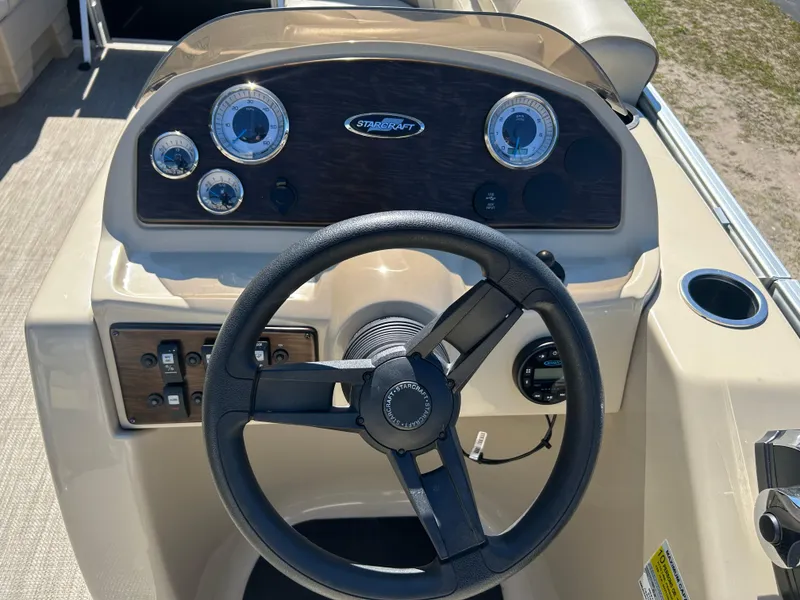 Slide: The Image of 2019 Starcraft EX 20 C boat dashboard with steering wheel and gauges. - 8