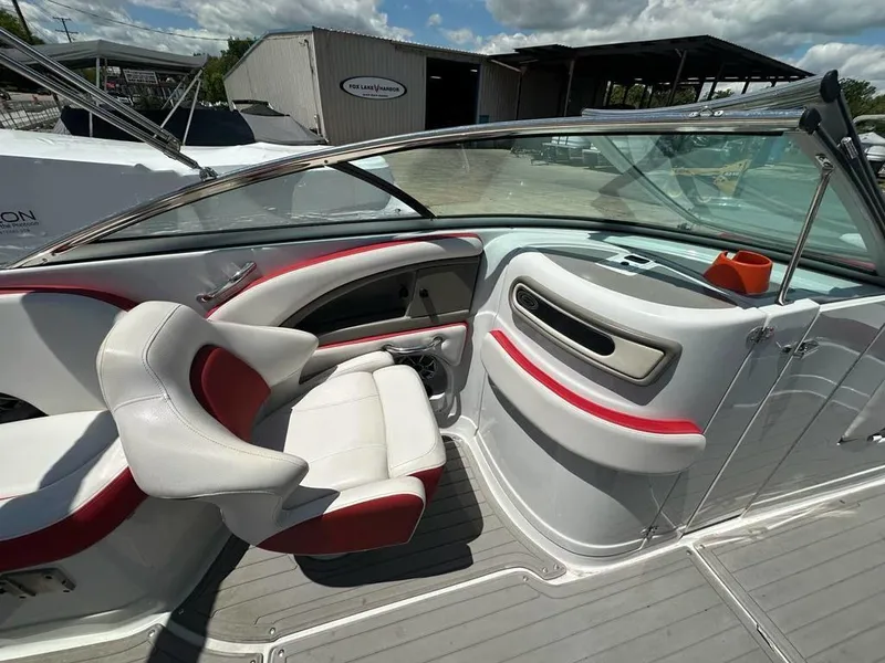Slide: The Image of 2017 Crownline E2 boat interior with white and red seating, windshield, and storage compartments. - 11