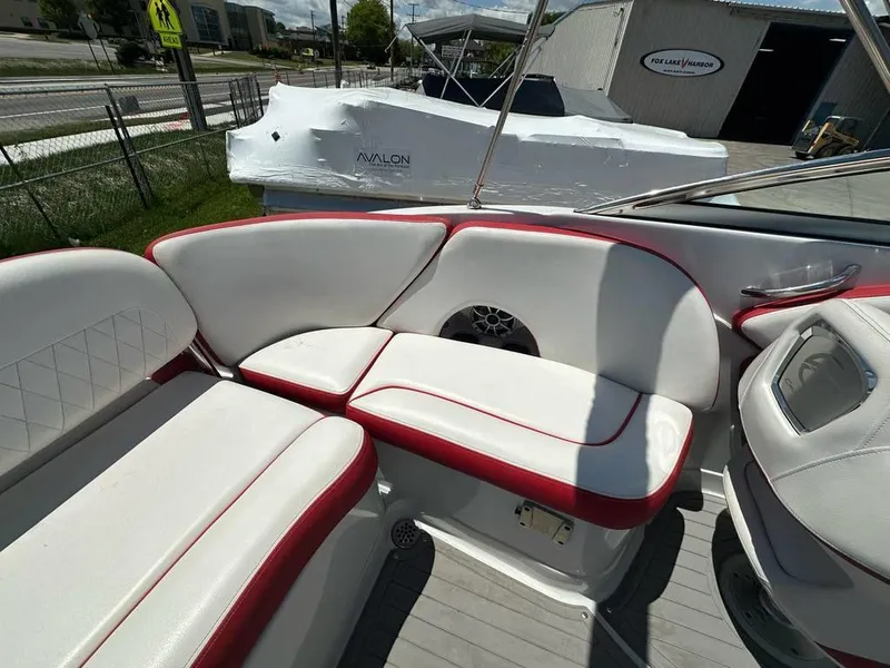 Slide: The Image of 2017 Crownline E2 boat interior with white and red seating, docked near Fox Lake Harbor. - 14