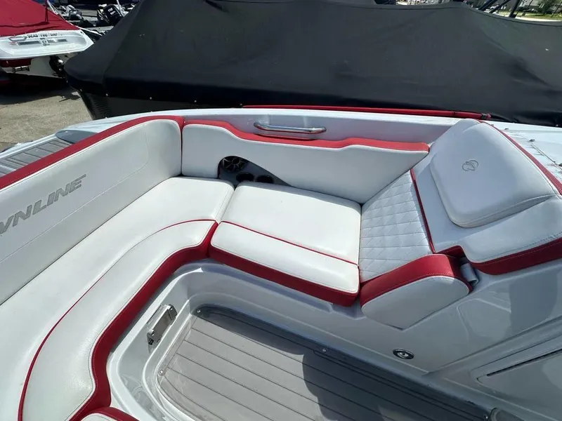 Slide: The Image of 2017 Crownline E2 boat interior with white and red seating, featuring sleek design and comfortable cushions. - 4