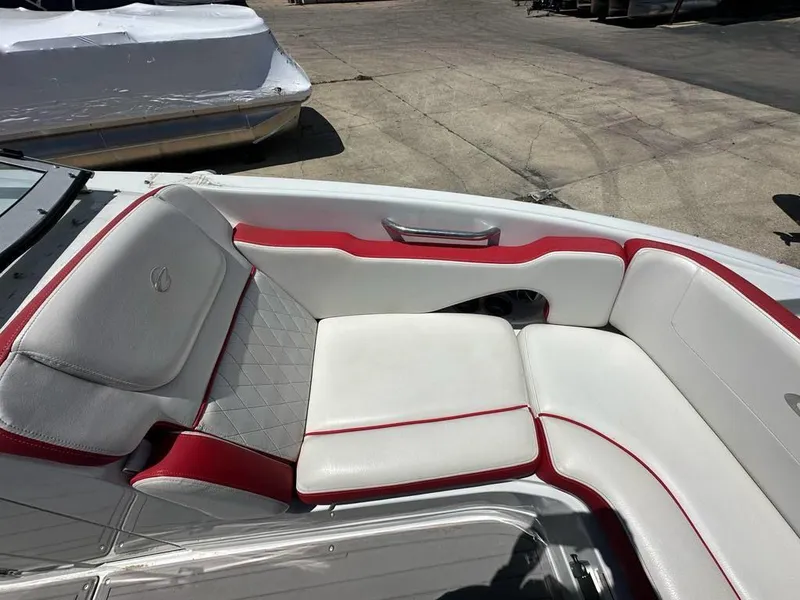Slide: The Image of 2017 Crownline E2 boat interior with white and red cushioned seating. - 6