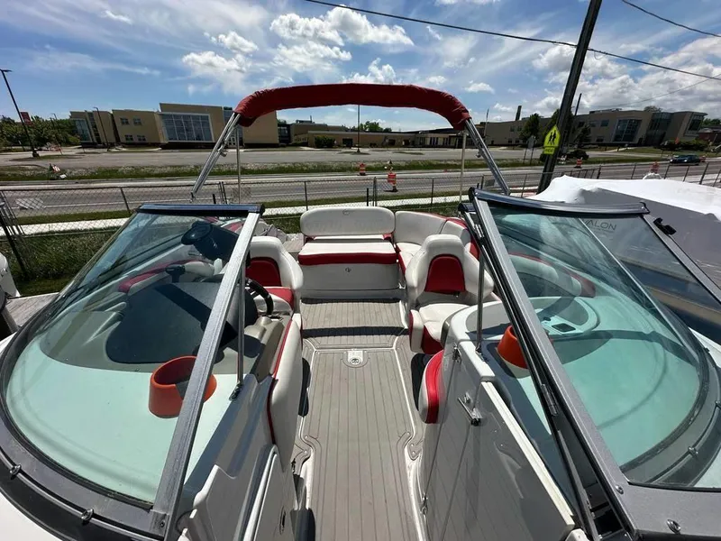 Slide: The Image of 2017 Crownline E2 boat interior with red and white seating, clear skies above. - 7