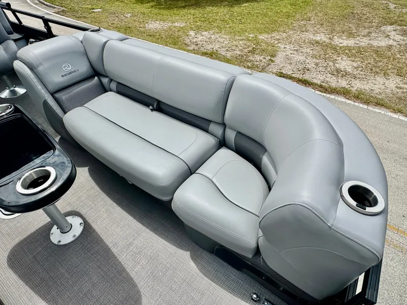 Slide: The Image of Gray seating on 2022 Regency 230 LE3 Sport boat with cup holders and table. - 10