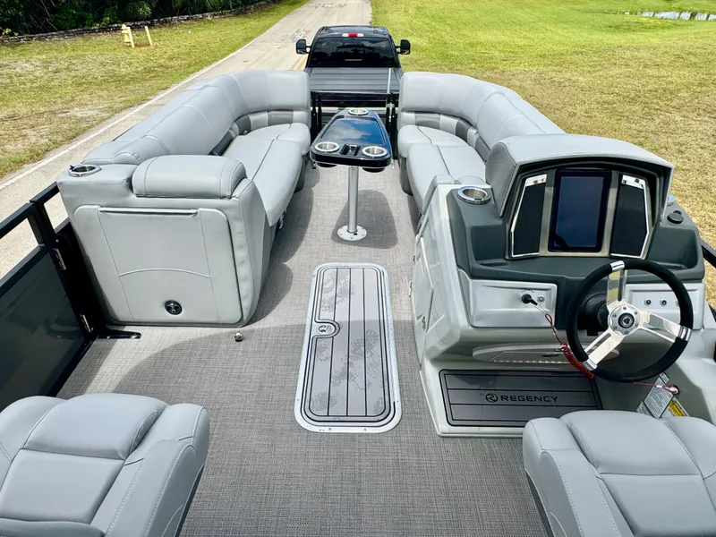 Slide: The Image of 2022 Regency 230 LE3 Sport pontoon boat with luxurious seating and modern dashboard. - 15