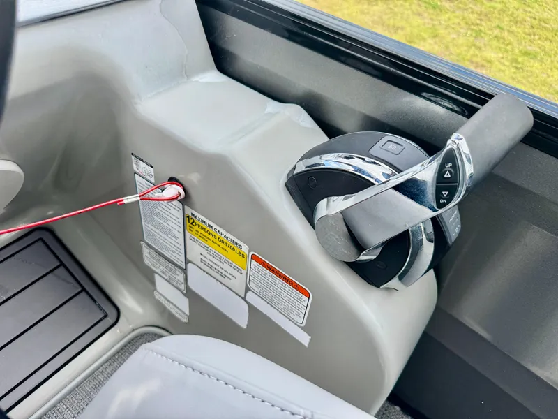 Slide: The Image of Control panel of 2022 Regency 230 LE3 Sport boat with throttle and safety features. - 18