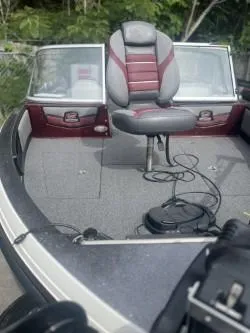 Slide: The Image of 2023 Ranger 1880MS boat with a red and gray seat, featuring a spacious deck. - 1