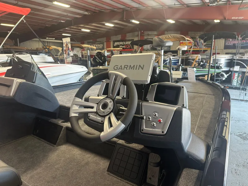 Slide: The Image of 2025 Tracker Savage 215 boat interior with Garmin navigation system in showroom. - 14